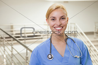 Nurse in a stairwell smiling