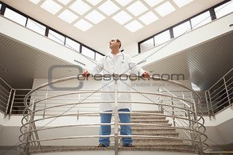 Doctor standing in stairwell looking around