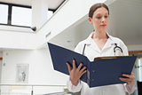 Female doctor reading folder