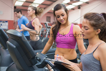 Female gym instructor and woman