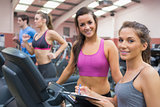 Happy women in the gym during assessment