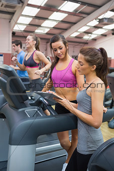 Female Gym Instructor and woman in the gym