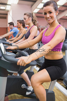 Woman happy on exercise bicycle