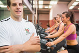 Man with arms crossed in gym