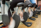 People riding on exercise bikes