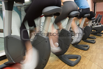 People riding on exercise bikes