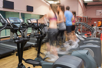 People working out on step machines at speed