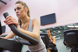 Woman training on exercise bike in a spinning class