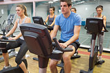 Spinning class riding on an exercise bikes