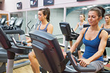 Women riding on exercise bikes in spinning class