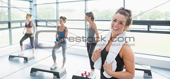 Happy woman taking a break at aerobics class
