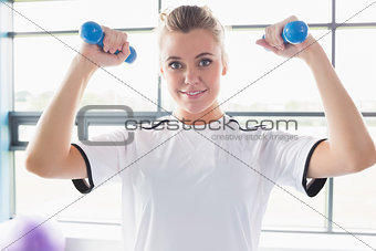 Female trainer lifting weights