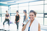 Woman with bottle of water in aerobics class