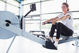 Concentrating  woman training on row machine