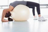 Woman stretching using exercise ball
