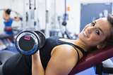 Smiling woman lifting weights