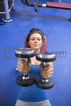 Woman straining to lift weights