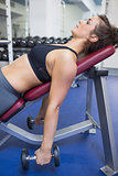 Woman lifting weights while lying down