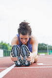 Woman stretching out on a track