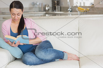 Young woman relaxing while reading a book