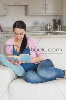 Young woman reading in the living room
