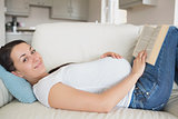 Pregnant woman relaxing in the living room
