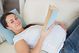 Young pregnant woman reading