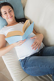 Prospective mother reading a book