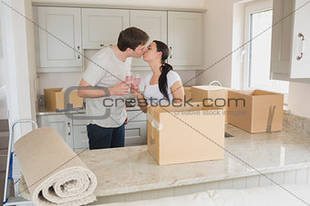 Happy couple kissing in the kitchen
