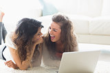 Two laughing women with a computer