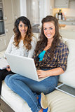 Smiling girls working on laptop