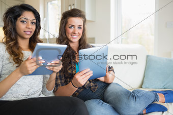Smiling women with their tablet computers
