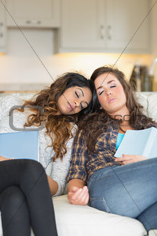 Two girls sleeping on couch