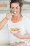 Happy girl eating cereal