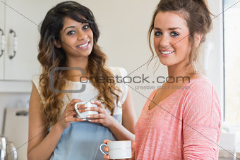 Happy women holding coffee cups