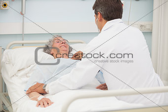 Doctor caring about elderly lady