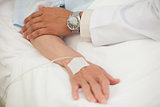 Doctor touching arm of elderly lady