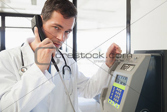 Doctor phoning in the hospital