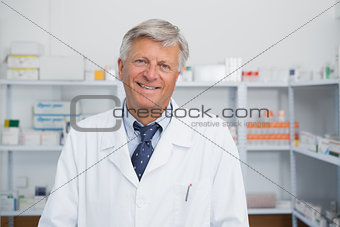 Smiling doctor in a pharmacy