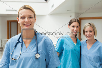 Two nurses in the background and one in the foreground