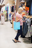 Woman is searching while holding a bag
