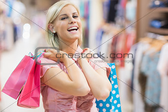 Woman laughing in clothes shop