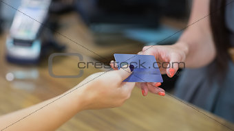 Woman handing over credit card