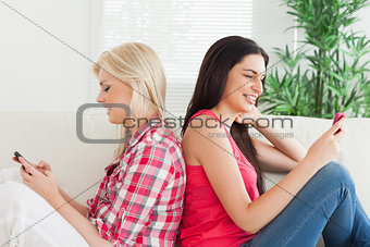 Women both looking at mobile phone