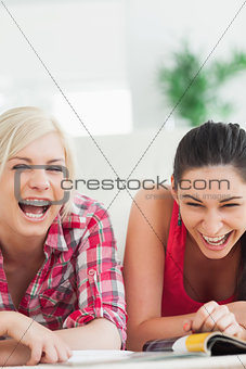 Women lying on the floor laughing