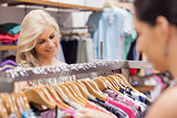 Woman looking at the clothes rack with friend