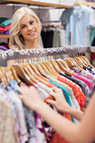Woman standing at the clothes rack smiling
