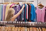 Woman searching clothes at the clothes rack