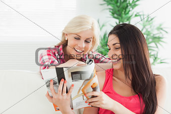 Women looking at the magazine smiling