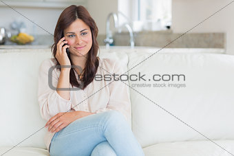 Woman sitting on the couch using her phone